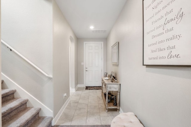 130 Mcginnis Trl, Kyle, TX 78640 - corridor with visible vents, baseboards, arched walkways, light tile patterned flooring, and stairs