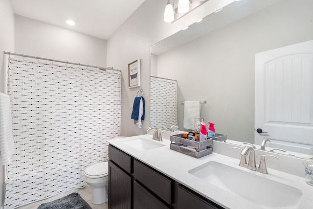 130 Mcginnis Trl, Kyle, TX 78640 - bathroom with a sink, double vanity, toilet, and a shower with shower curtain