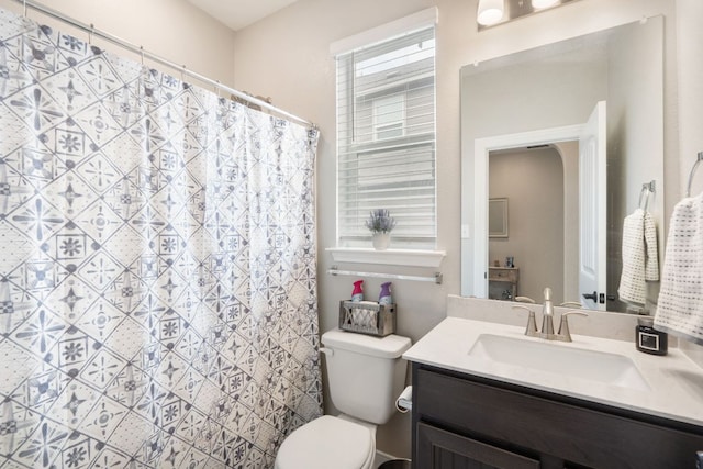 130 Mcginnis Trl, Kyle, TX 78640 - bathroom featuring toilet, vanity, and curtained shower