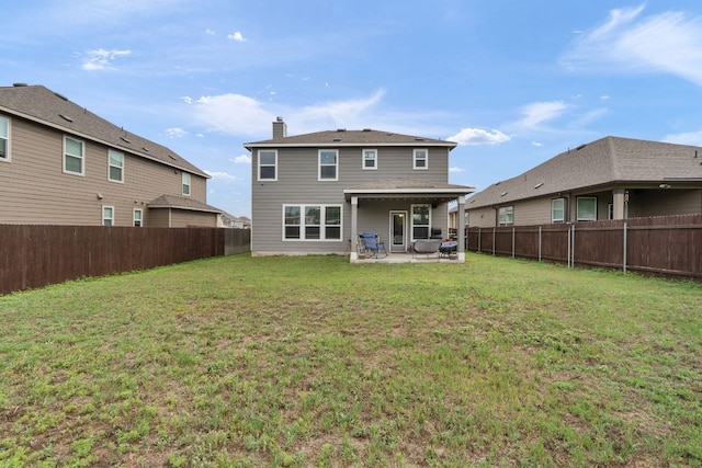 130 Mcginnis Trl, Kyle, TX 78640 - rear view of house featuring a lawn, a chimney, a patio, and a fenced backyard