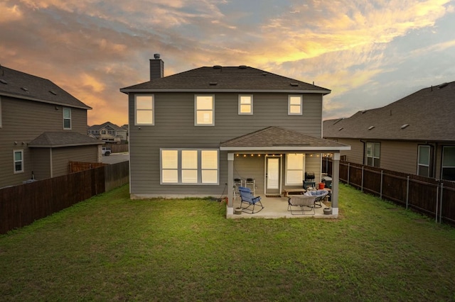 130 Mcginnis Trl, Kyle, TX 78640 - back of house featuring a fenced backyard, a patio, a yard, and a chimney