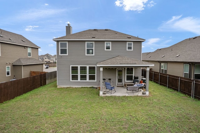 130 Mcginnis Trl, Kyle, TX 78640 - rear view of house with a lawn, a patio, and a fenced backyard