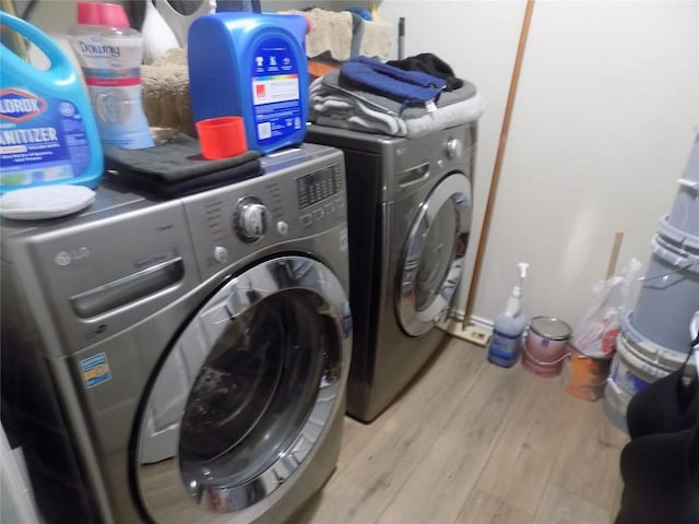 124 Rearden Blvd, Jarrell, TX 76537 - laundry area with washing machine and clothes dryer and wood finished floors