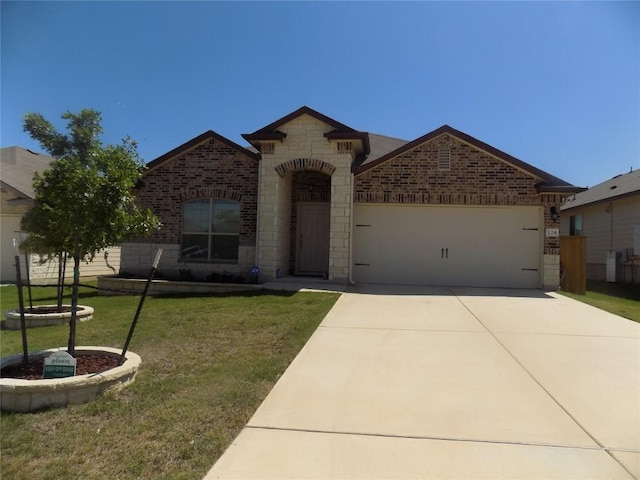 view of front of home featuring an attached garage, stone siding, concrete driveway, a front yard, and brick siding