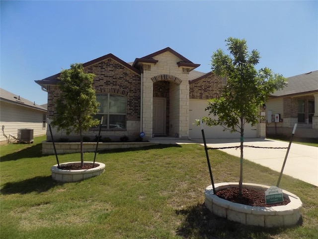 124 Rearden Blvd, Jarrell, TX 76537 - french country inspired facade with concrete driveway, an attached garage, central AC, stone siding, and a front yard