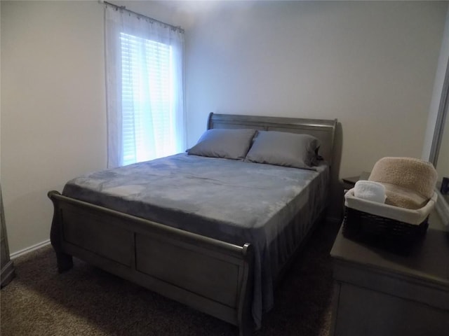 bedroom featuring dark colored carpet