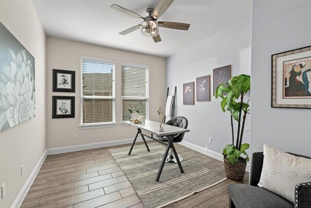 home office with baseboards, a ceiling fan, and wood finished floors