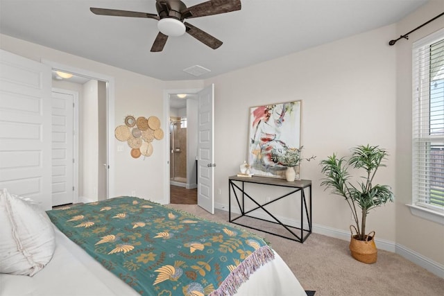 carpeted bedroom with visible vents, baseboards, and a ceiling fan