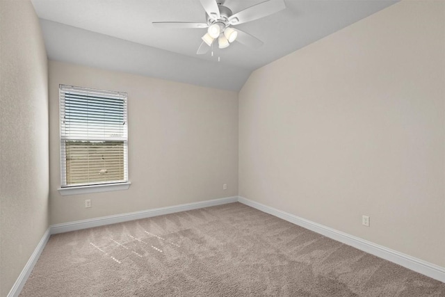 unfurnished room featuring baseboards, carpet flooring, ceiling fan, and vaulted ceiling