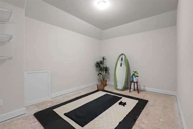interior space featuring vaulted ceiling and baseboards