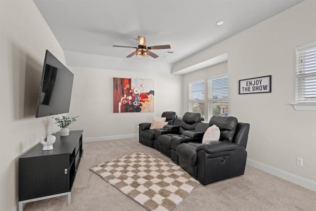 carpeted living room with a wealth of natural light, baseboards, a ceiling fan, and visible vents