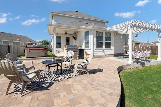 back of house with a patio, a ceiling fan, a pergola, a hot tub, and a fenced backyard