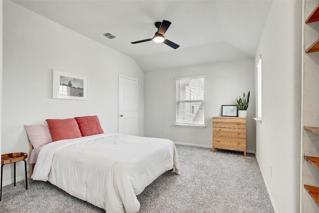 bedroom with a ceiling fan, baseboards, visible vents, vaulted ceiling, and light colored carpet