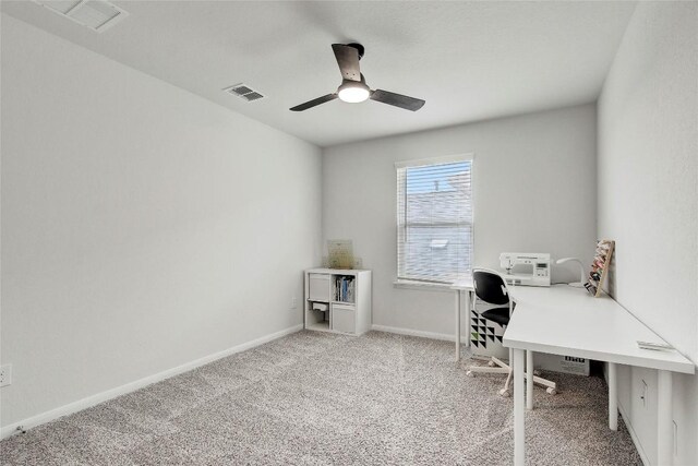 office space with baseboards, ceiling fan, carpet flooring, and visible vents
