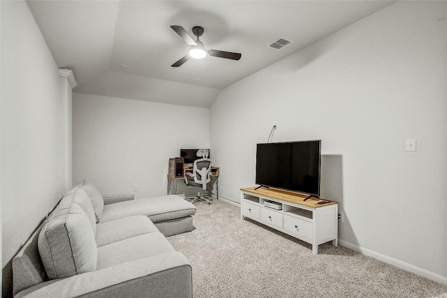 living room featuring light colored carpet, lofted ceiling, ceiling fan, and visible vents