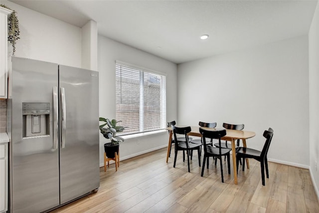 dining area with baseboards, recessed lighting, and light wood-type flooring