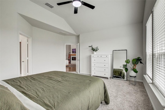 bedroom with vaulted ceiling, multiple windows, carpet flooring, and visible vents