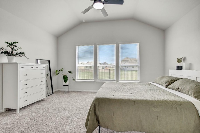 bedroom featuring vaulted ceiling, ceiling fan, light carpet, and baseboards