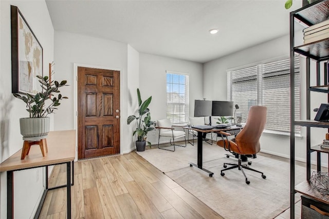 office space featuring baseboards, recessed lighting, and wood finished floors