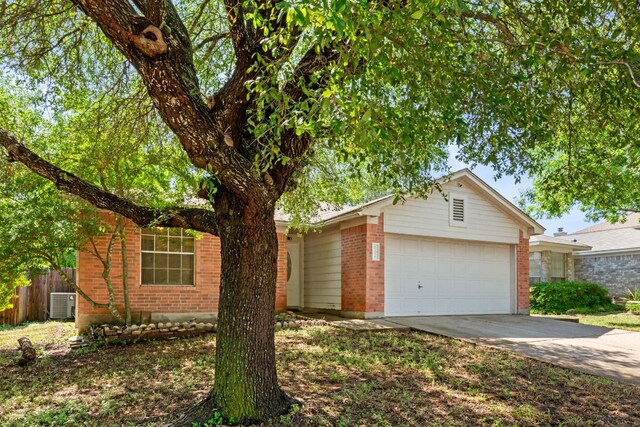 single story home with brick siding, an attached garage, concrete driveway, fence, and cooling unit