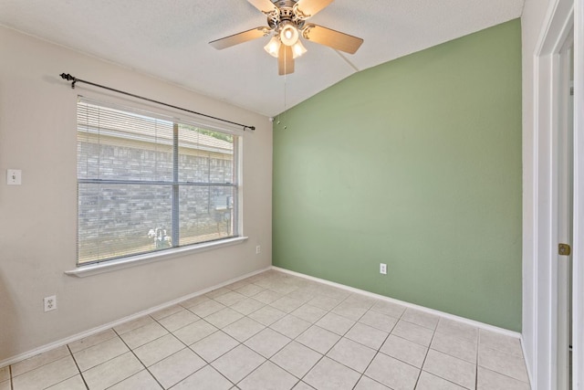 unfurnished room featuring lofted ceiling, ceiling fan, baseboards, and light tile patterned floors