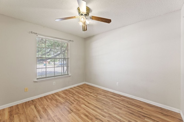 empty room featuring light wood finished floors, a ceiling fan, baseboards, and a textured ceiling