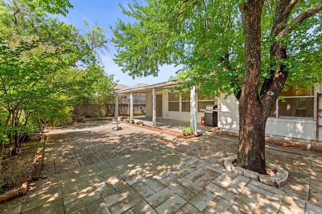 rear view of property with a patio and fence