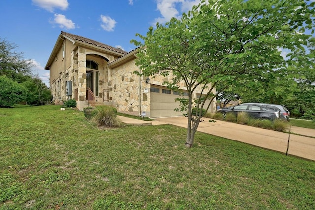 400 Hummingbird Ln Unit A, Austin, TX 78734 - mediterranean / spanish-style house featuring concrete driveway, a garage, a front yard, and stone siding