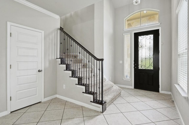 400 Hummingbird Ln Unit A, Austin, TX 78734 - entryway with light tile patterned floors, stairway, and ornamental molding