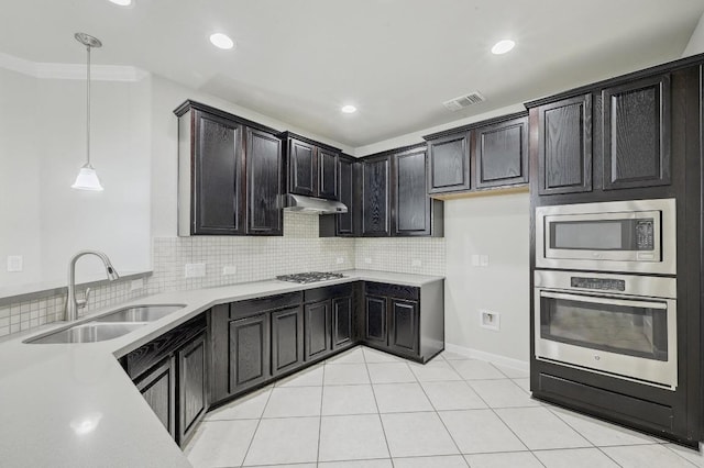 400 Hummingbird Ln Unit A, Austin, TX 78734 - kitchen featuring stainless steel appliances, light countertops, decorative backsplash, pendant lighting, and under cabinet range hood