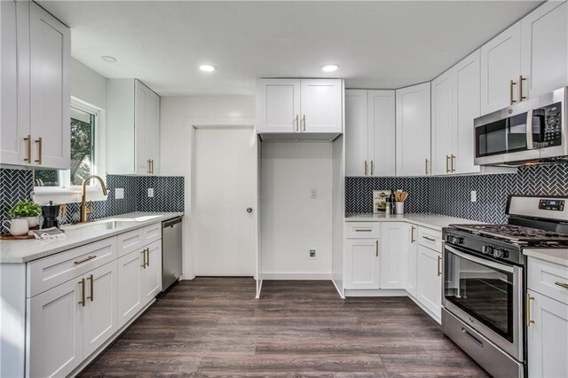 6220 Blarwood Dr, Austin, TX 78745 - kitchen featuring appliances with stainless steel finishes, a sink, decorative backsplash, light countertops, and recessed lighting
