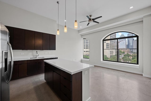 507 Sabine St Unit 503, Austin, TX 78701 - kitchen with a sink, stainless steel refrigerator with ice dispenser, ceiling fan, light countertops, and a kitchen island
