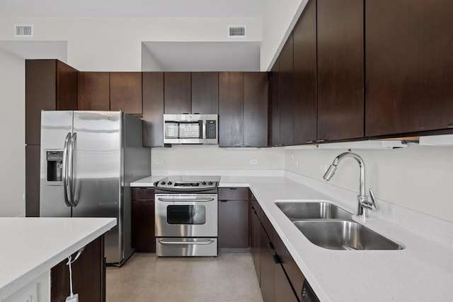507 Sabine St Unit 503, Austin, TX 78701 - kitchen featuring light countertops, stainless steel appliances, dark brown cabinetry, and a sink