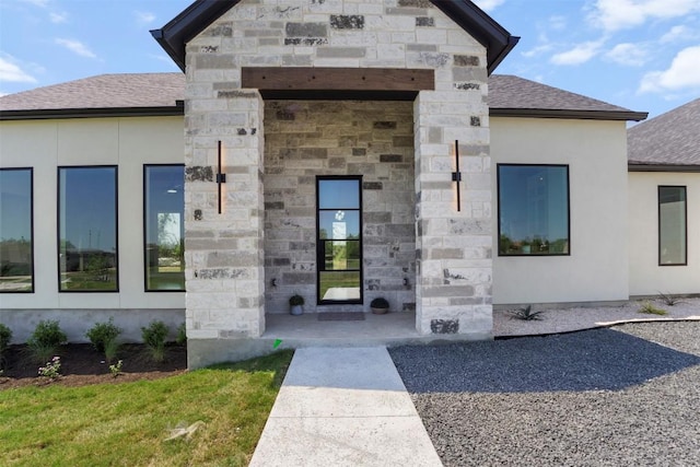 17109 Saint Therese Rd, Manor, TX 78653 - entrance to property featuring a shingled roof, stone siding, and stucco siding