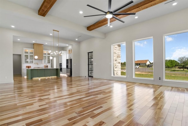 17109 Saint Therese Rd, Manor, TX 78653 - unfurnished living room featuring beam ceiling, light wood-style flooring, a chandelier, recessed lighting, and ceiling fan