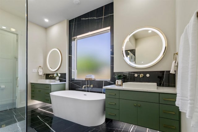 17109 Saint Therese Rd, Manor, TX 78653 - full bathroom with tile walls, two vanities, and a freestanding tub