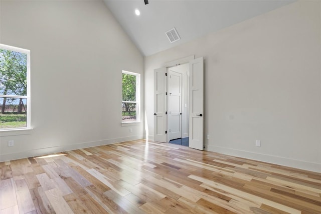 17109 Saint Therese Rd, Manor, TX 78653 - unfurnished bedroom with high vaulted ceiling, light wood-style flooring, and recessed lighting