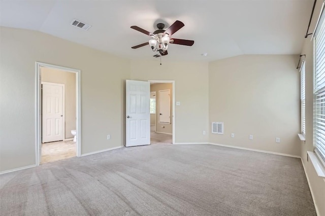 unfurnished bedroom featuring lofted ceiling, carpet flooring, and visible vents