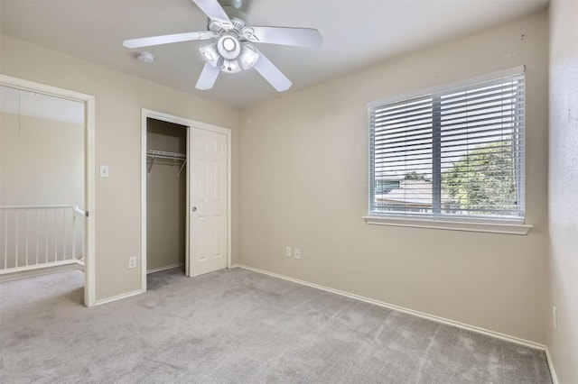 unfurnished bedroom with baseboards, a closet, ceiling fan, and carpet floors