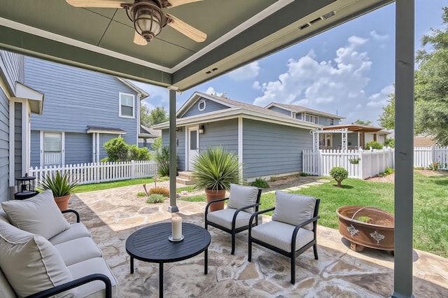 view of patio featuring outdoor lounge area, fence, and ceiling fan
