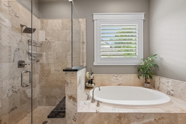 full bathroom featuring a shower stall and a garden tub