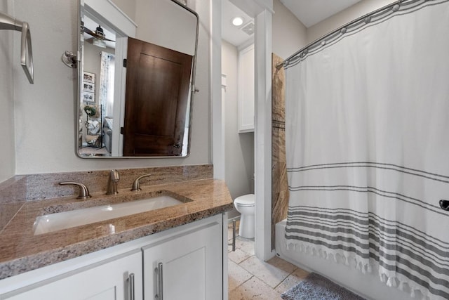 full bath with shower / bath combination with curtain, toilet, vanity, and stone tile flooring