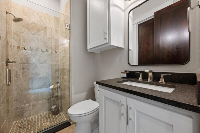 full bathroom featuring vanity, toilet, and a stall shower