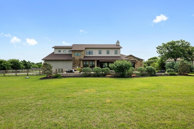view of front of house with a front lawn, a chimney, and fence