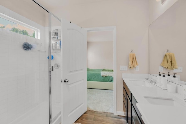 310 Garcitas Creek Ln, Hutto, TX 78634 - ensuite bathroom with wood finished floors, a stall shower, and double vanity