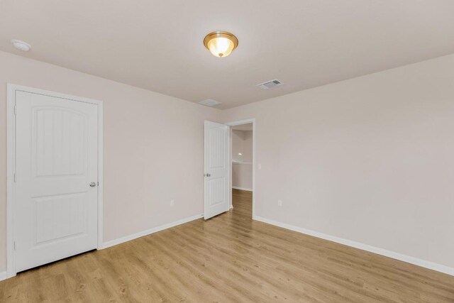 310 Garcitas Creek Ln, Hutto, TX 78634 - empty room featuring light wood-style floors, baseboards, and a smoke detector