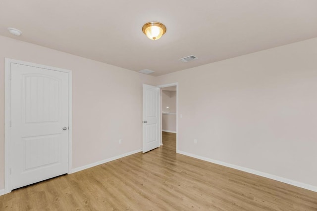 310 Garcitas Creek Ln, Hutto, TX 78634 - empty room with light wood-style flooring and a smoke detector