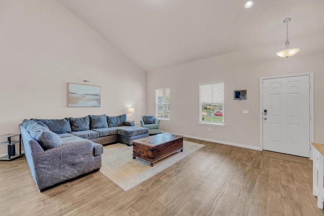 310 Garcitas Creek Ln, Hutto, TX 78634 - living room featuring high vaulted ceiling, light wood-style flooring, and baseboards