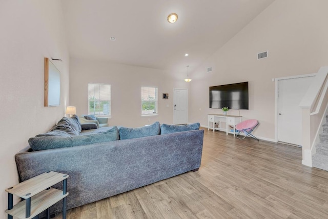 310 Garcitas Creek Ln, Hutto, TX 78634 - living room featuring high vaulted ceiling, wood finished floors, stairs, and baseboards