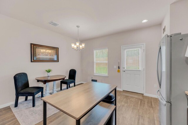 310 Garcitas Creek Ln, Hutto, TX 78634 - dining space featuring light wood-type flooring, a chandelier, and baseboards